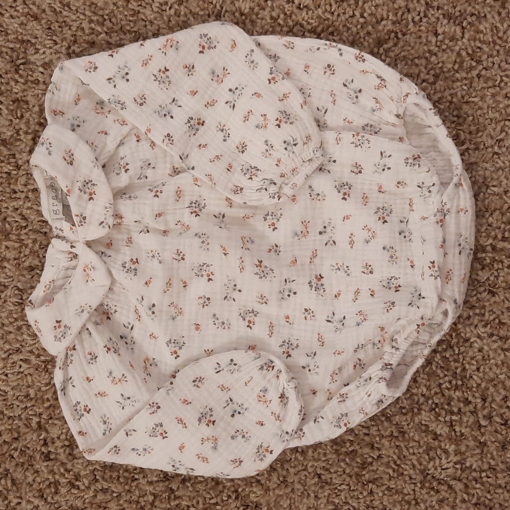 6 months Grace. bodysuit. White with tiny floral print in blue and salmon color